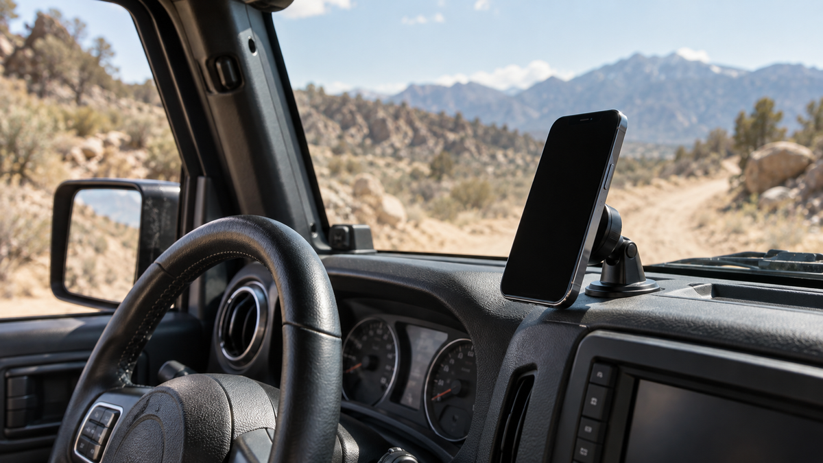 Unbranded magnetic phone mount securing a blank-screen phone inside a parked off-road vehicle