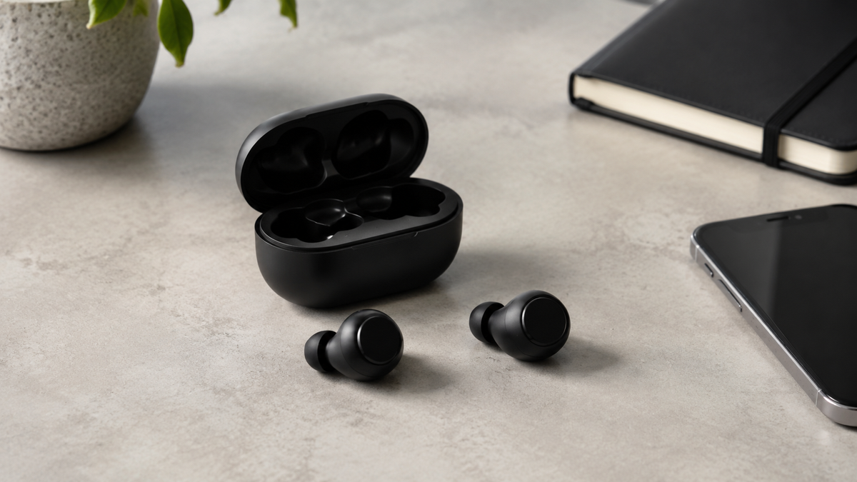 Unbranded Bluetooth earbuds and charging case on a clean desk