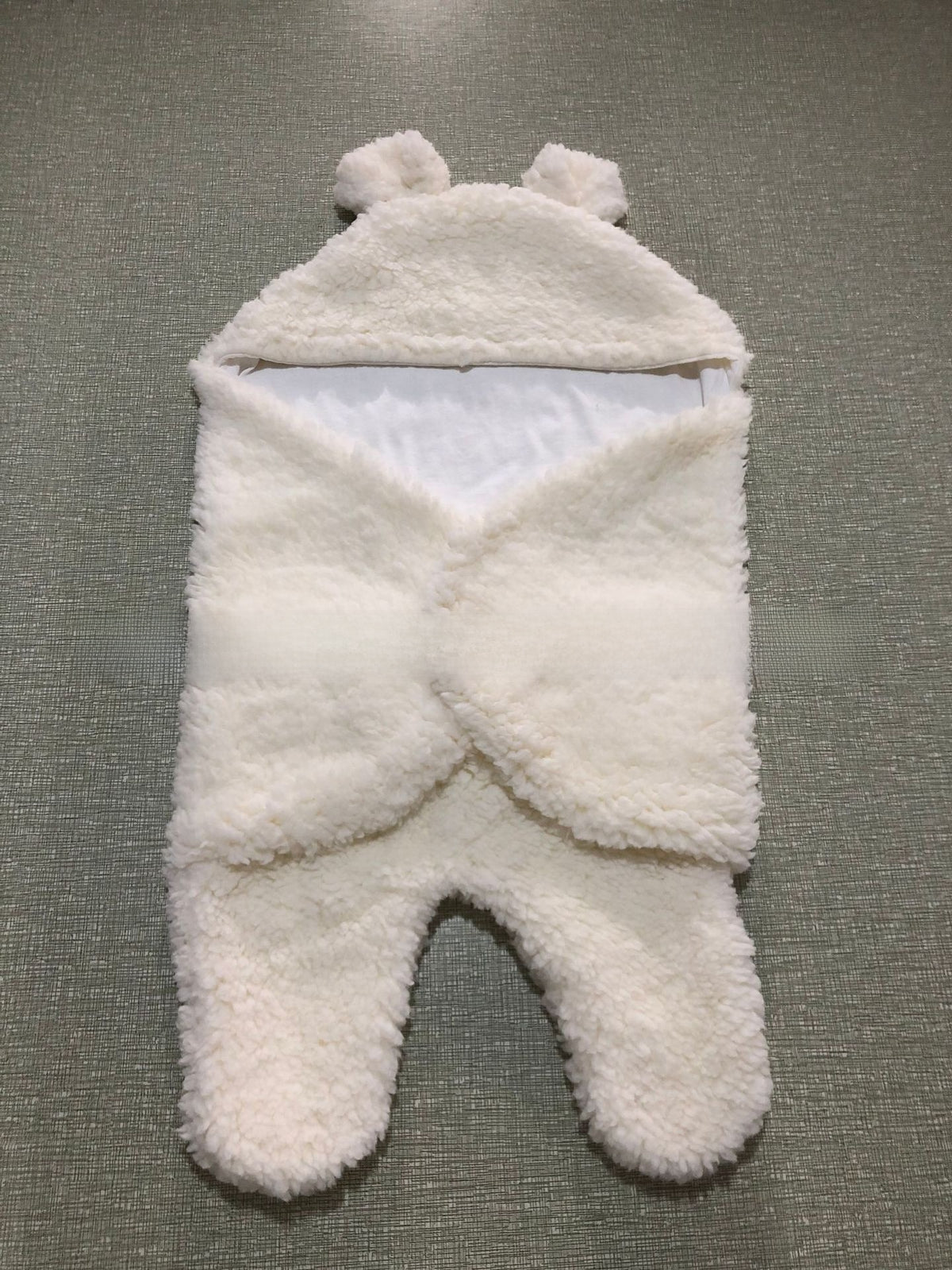 newborn hugging clothing package