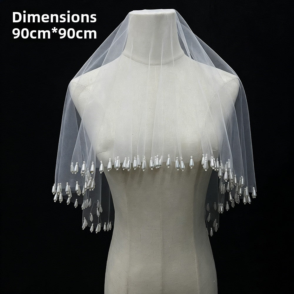 The bridal pearl tassel veil with lampshade-style wedding photography props