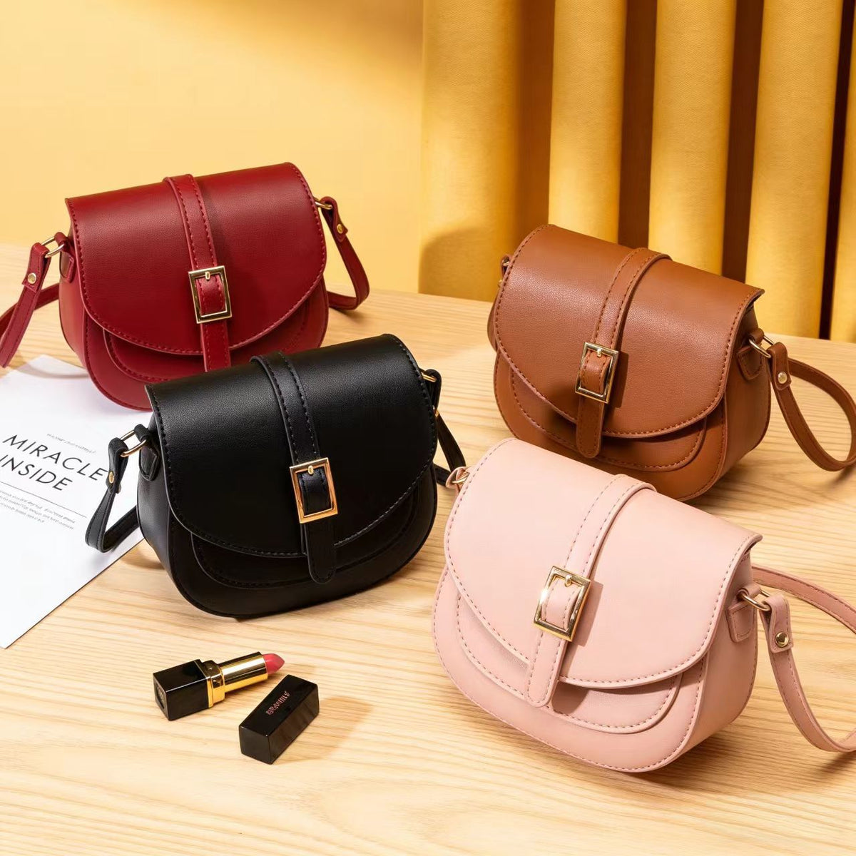 Simple metal-buckle flap crossbody saddle bag with an adjustable shoulder strap.